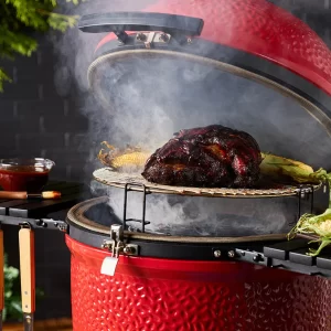 red-kamado-joe-ceramic-smoker-with-meat-cooking